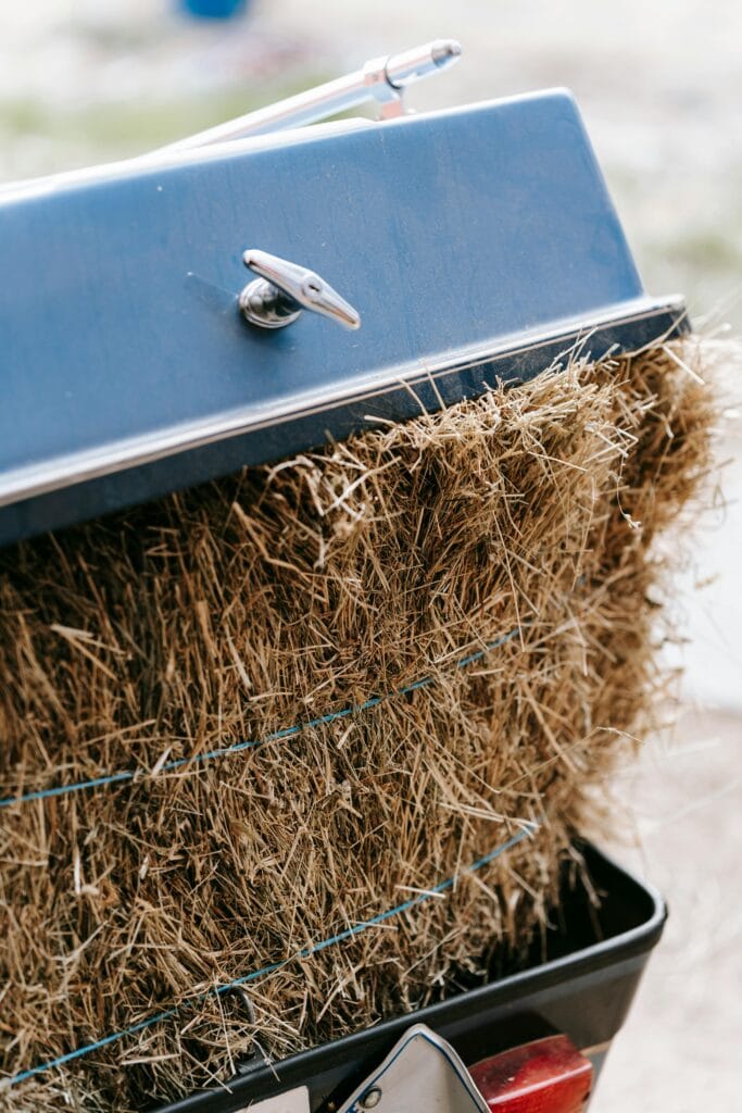 pexels photo 7882297 7882297 A detailed close-up of hay bales inside a blue metallic trailer, capturing texture and color.